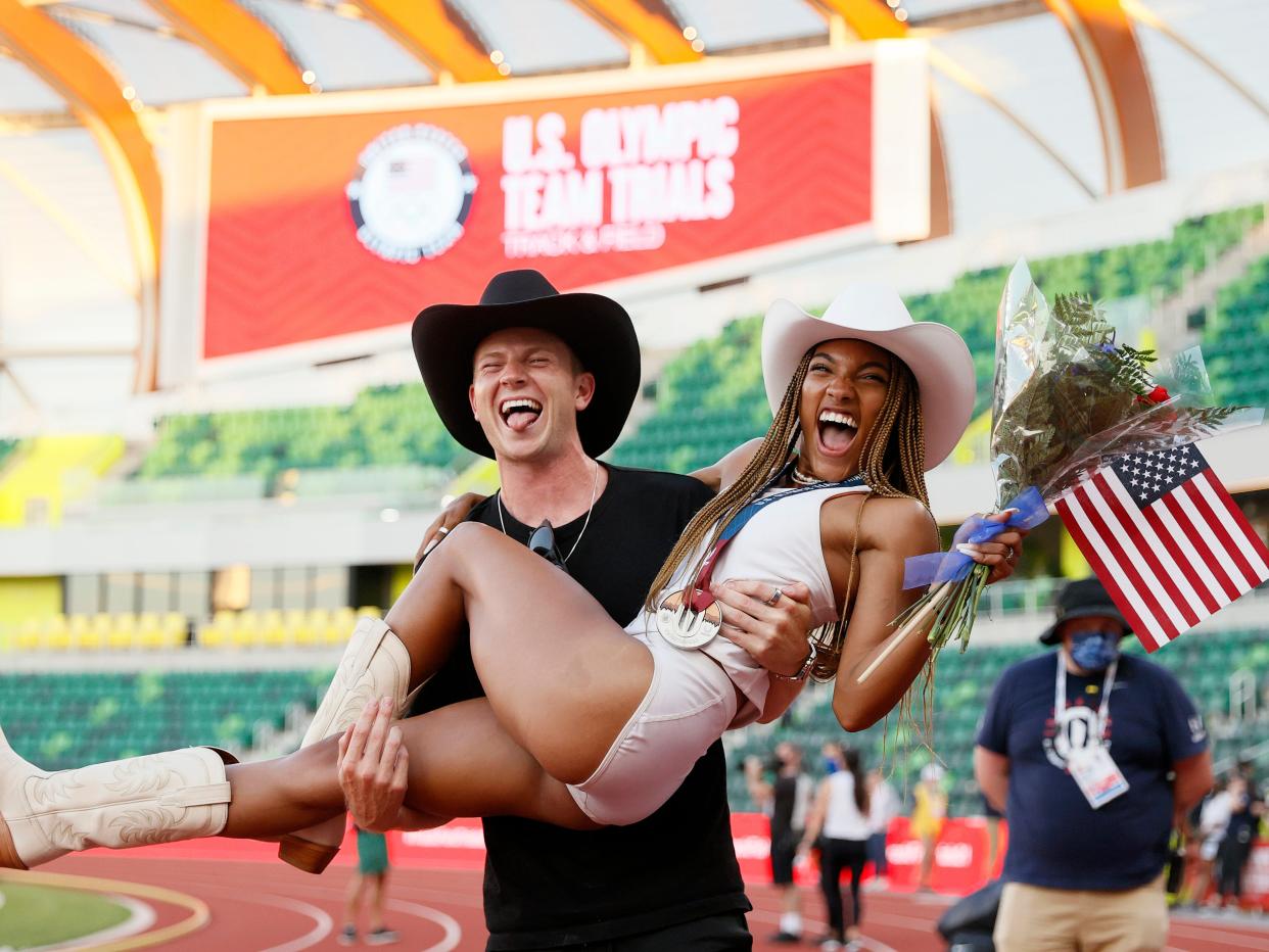 Hunter Woodhall holds Tara Davis in his arms