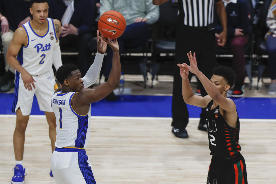 Pittsburgh's Xavier Johnson (1) shoots a three-point basket over Miami's Isaiah Wong (2) during the second half of an NCAA college basketball game, Sunday, Feb. 2, 2020, in Pittsburgh. (AP Photo/Keith Srakocic)