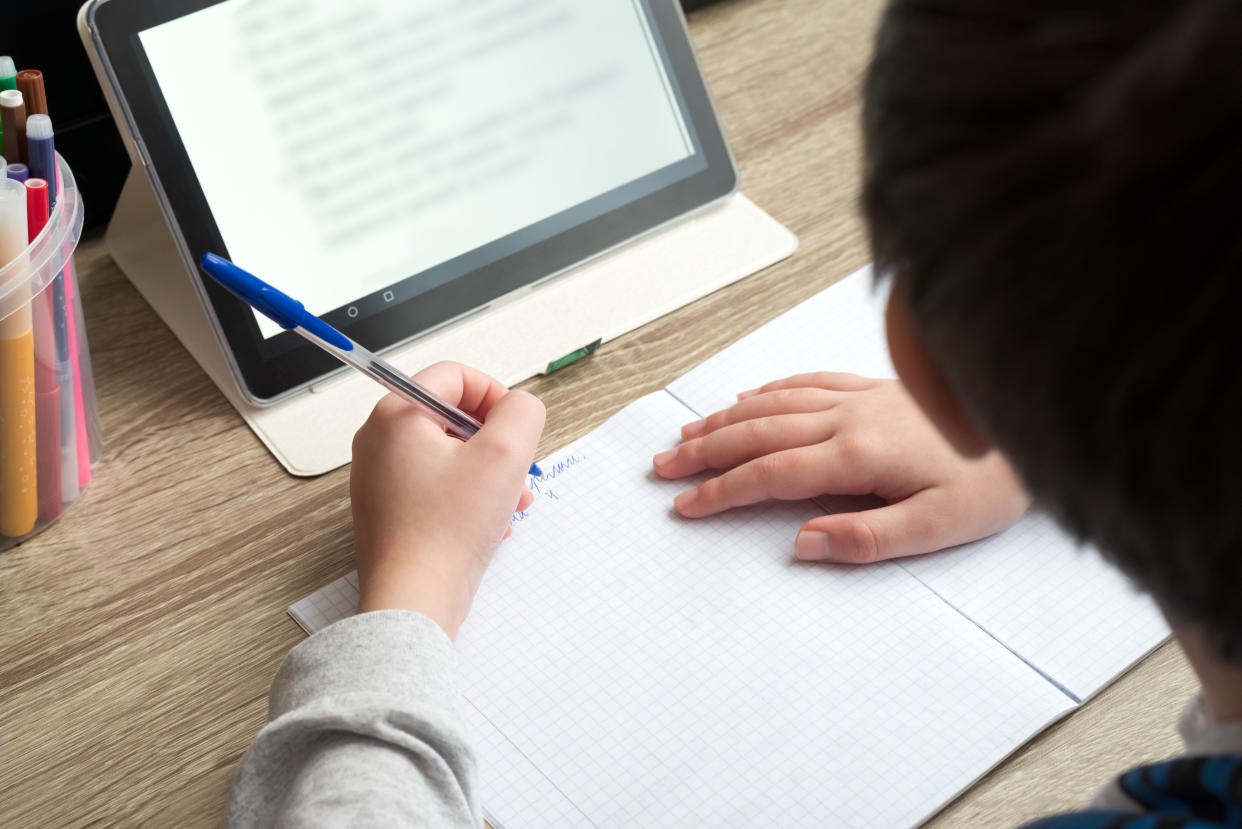 A boy doing homework. 