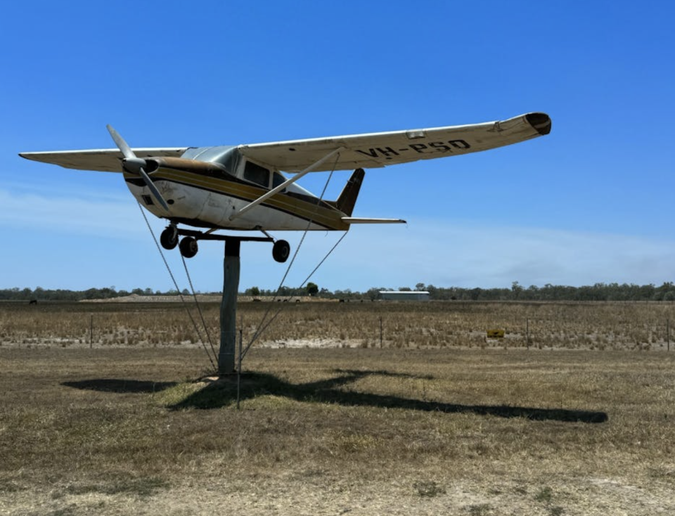 A light aircraft on an old power pole at the Row of Machinery. 