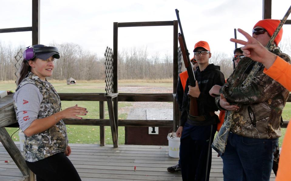 Random Lake High School life sciences teacher Natalie Weeks talks to her students during a skeet shooting session which is part of a wilderness science class, Wednesday, November 9, 2022, in Cascade, Wis.