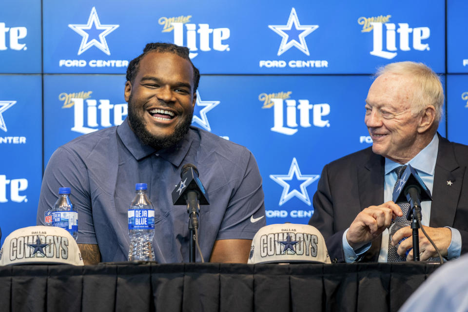 Dallas Cowboys first round draft pick Mazi Smith, a defensive tackle from Michigan, speaks to the media as owner Jerry Jones listens during a press conference Friday, April 28, 2023, at the Dallas Cowboys headquarters in Frisco, Texas. (AP Photo/Jeffrey McWhorter)