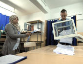 An election worker empties a ballot box during the presidential elections in a polling station in the Algerian capital, Algiers, Thursday, April 17, 2014. Algerians are trickling into the polls to elect a new president of this oil-rich North African nation in an election expected to be won by the ailing incumbent. President Bouteflika has ruled this nation for the past 15 years and, despite suffering from a stroke, is running for a fourth term on a platform of stability. Six candidates are running for the powerful presidency in the April 17 elections. (AP Photo/Sidali djarboub)