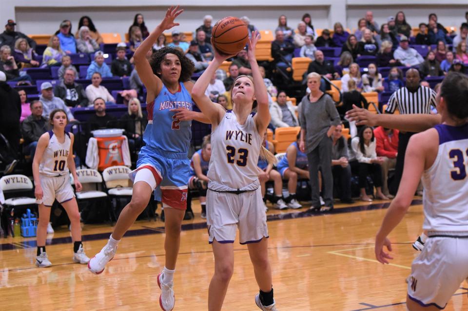 Wylie's Kaylan Adams (23) goes up for a shot during Friday's District 4-5A opener against Lubbock Monterey at Bulldog Gym on Jan. 7, 2022. The Lady Bulldog fell 58-40.