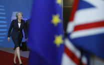 British Prime Minister Theresa May, left, arrives for an EU summit in Brussels, Wednesday, Oct. 17, 2018. European Union leaders are converging on Brussels for what had been billed as a "moment of truth" Brexit summit but which now holds little promise for a breakthrough. (AP Photo/Alastair Grant)