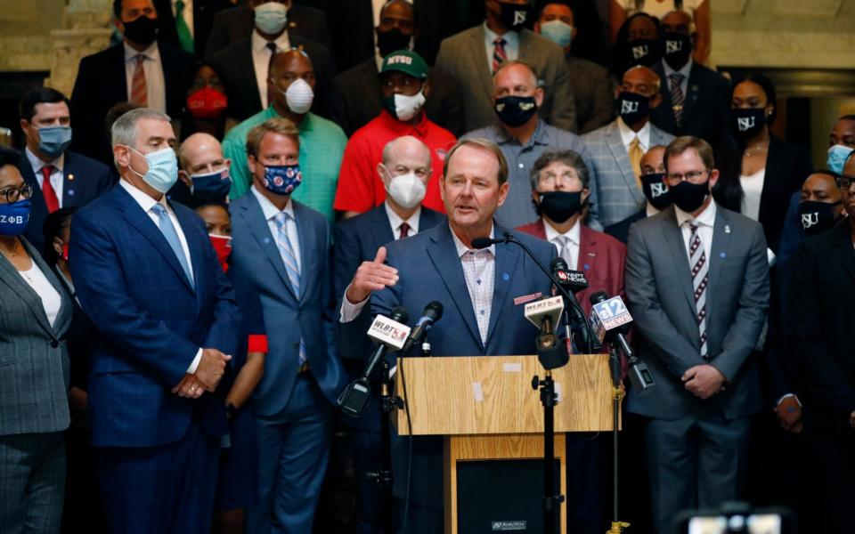 Mississippi basketball coach, Kermit Davis, centre, joins other athletic staff from the state's public universities calling for a change in the Mississippi state flag, during a joint news conference at the Capitol in Jackson, Miss. - AP