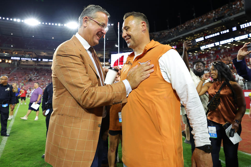 Texas athletic director Chris Del Conte congratulates coach Steve Sarkisian after the Longhorns beat Alabama on Sept. 9, 2023. (Kevin C. Cox/Getty Images)