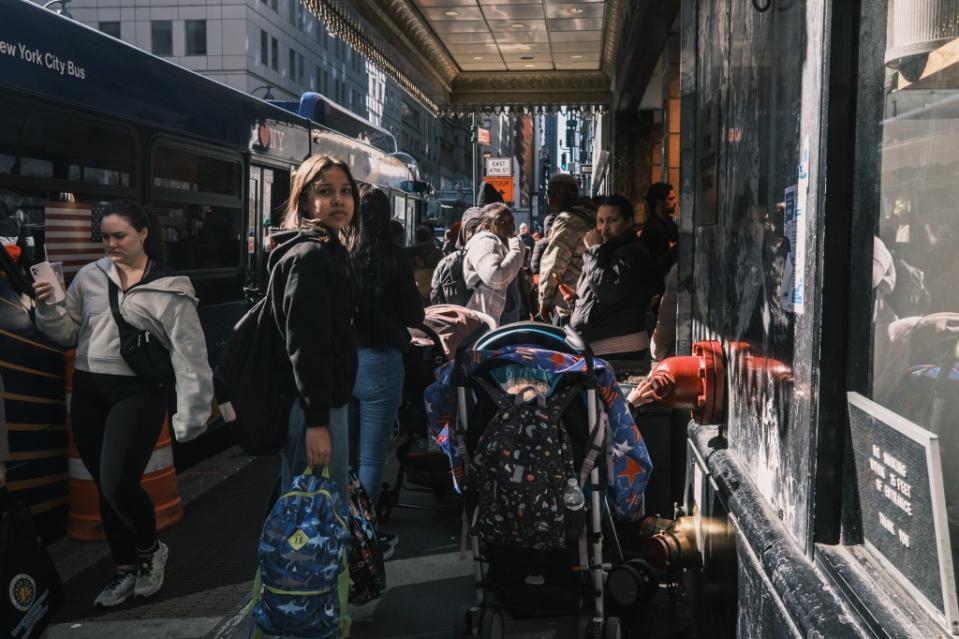 Migrants seeking asylum in the United States gather outside of hotel. Stephen Yang