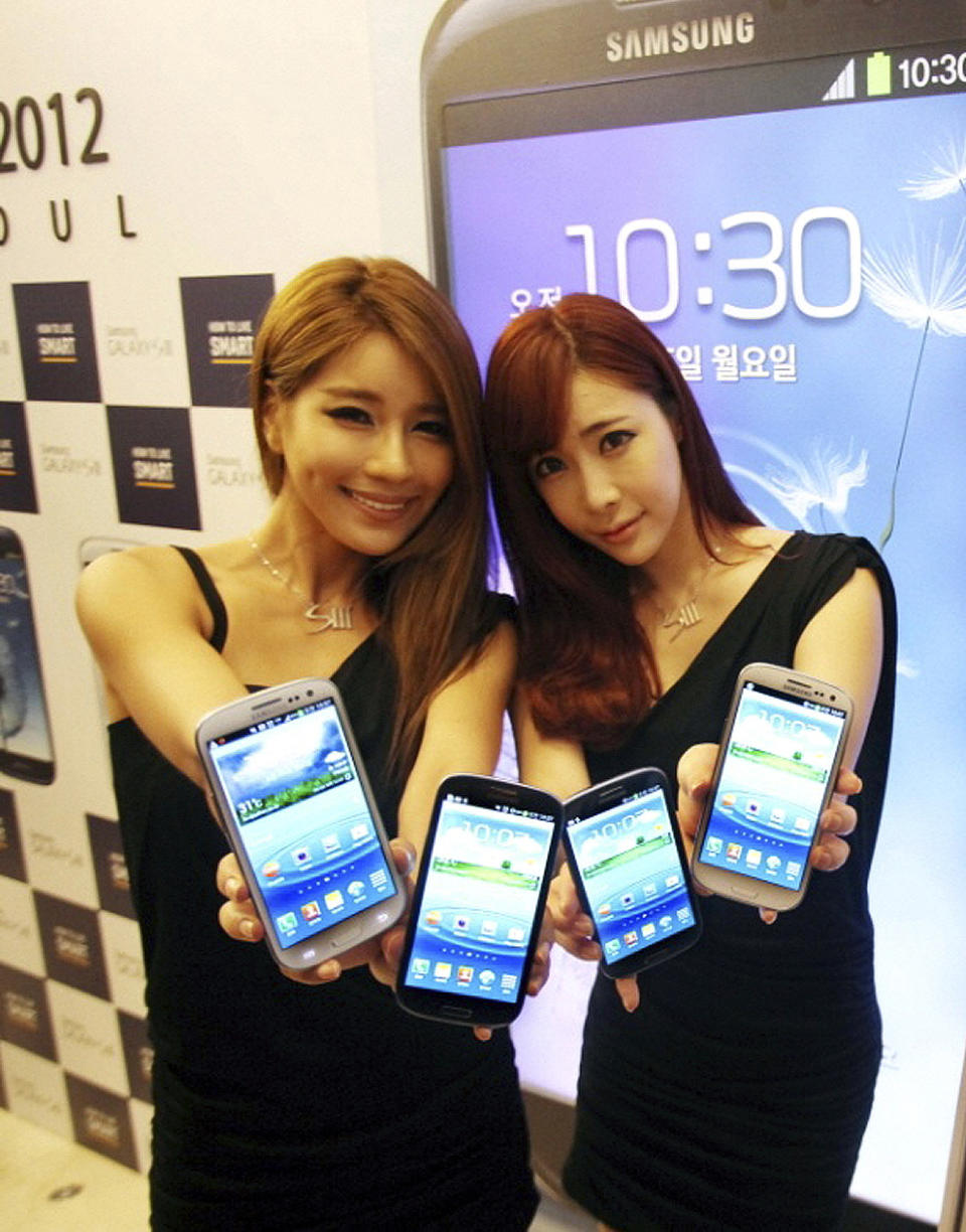 In this photo released by Samsung Electronics Co., models display Samsung Electronics' newest smartphone Galaxy S III during its world tour in Seoul, South Korea, Monday, June 25, 2012. Samsung Electronics, the world's top mobile phone maker, said Monday it expects global sales of the latest Galaxy smartphone to surpass 10 million in July even as it struggles to keep up with demand because of component shortages. (AP Photo/Samsung Electronics) NO SALES