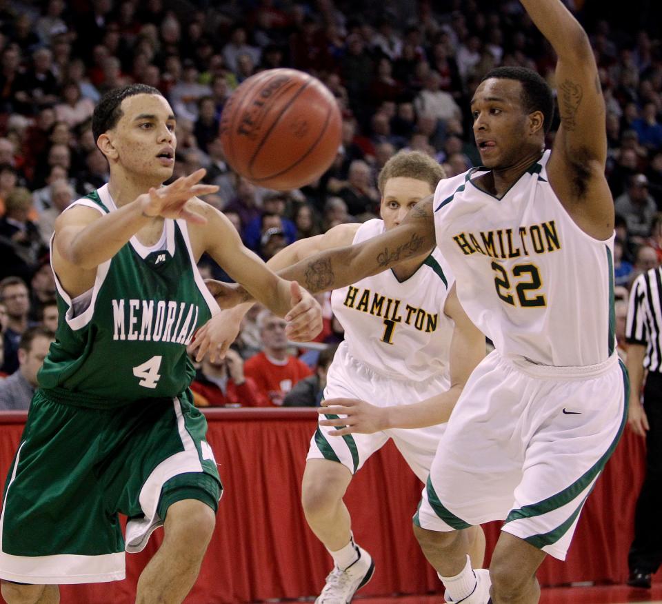 Madison Memorial's Brendan Ortiz gets a pass away from Milwaukee Hamilton's Itavian Belcer during the WIAA state basketball tournament at the Kohl Center Friday, March 18, 2011.