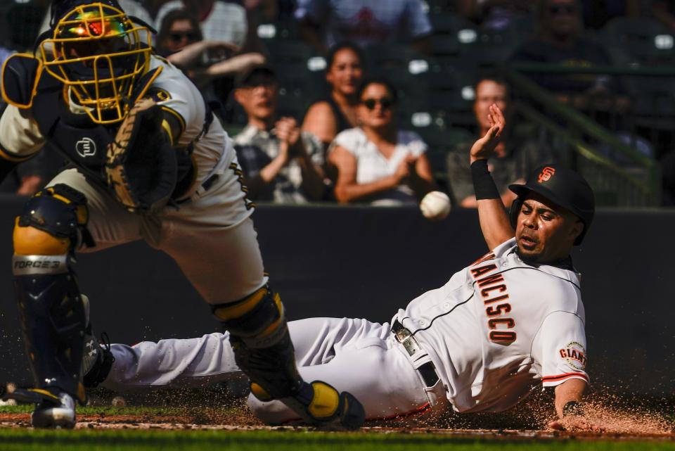 San Francisco Giants' LaMonte Wade Jr. scores past Milwaukee Brewers catcher Omar Narvaez at home during the third inning of game 1 of a doubleheader baseball game Thursday, Sept. 8, 2022, in Milwaukee. Wade Jr. scored on a hit by Mike Yastrzemski. (AP Photo/Morry Gash)