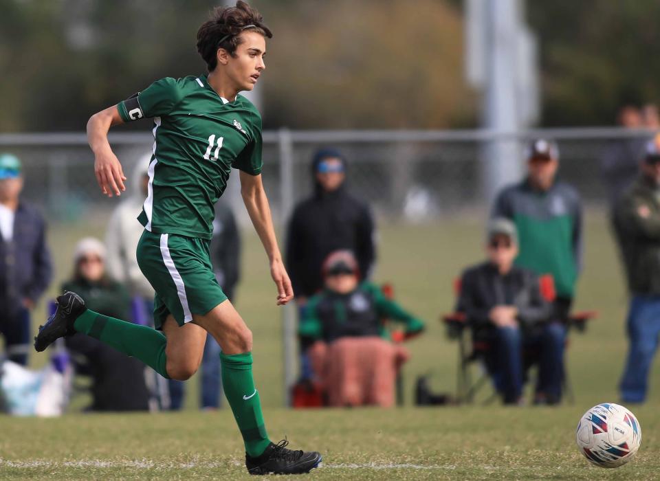 Flagler Palm Coast's Rami Amiri (11) dribbles the ball down the field during the Five Star Conference boys and girls soccer quarterfinals at Ormond Beach Sports Complex on Saturday, Jan.13th, 2024.