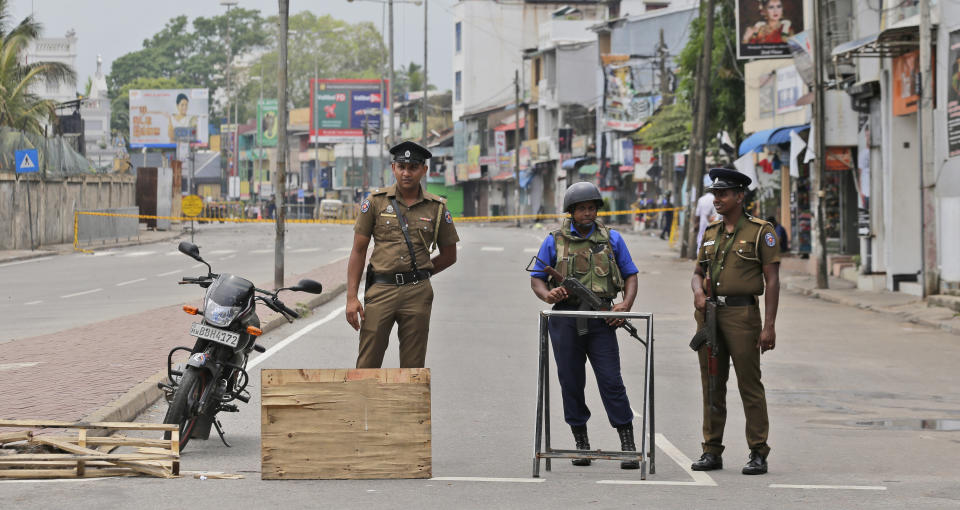 Sri Lankan policemen and a Naval soldier stand guard at a Check point in Colombo, Sri Lanka, Monday, April 29, 2019. The Catholic Church in Sri Lanka says the government should crack down on Islamic extremists with more vigor "as if on war footing" in the aftermath of the Easter bombings. (AP Photo/Eranga Jayawardena)
