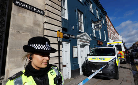 A police officer guards Zizzi's restaurant where Sergei Skripal and his daughter Yulia are known to have visited shortly before they were found in the centre of Salisbury, Britain, March 8, 2018. REUTERS/Peter Nicholls