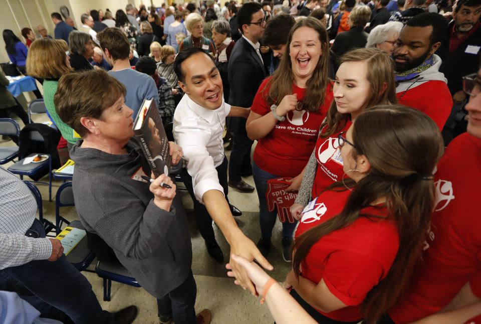 Former Housing and Urban Development Secretary and 2020 Democratic presidential hopeful Julian Castro, center, greets Iowa State students at the Story County Democrats' annual soup supper fundraiser, Saturday, Feb. 23, 2019, in Ames, Iowa. (AP Photo/Charlie Neibergall)