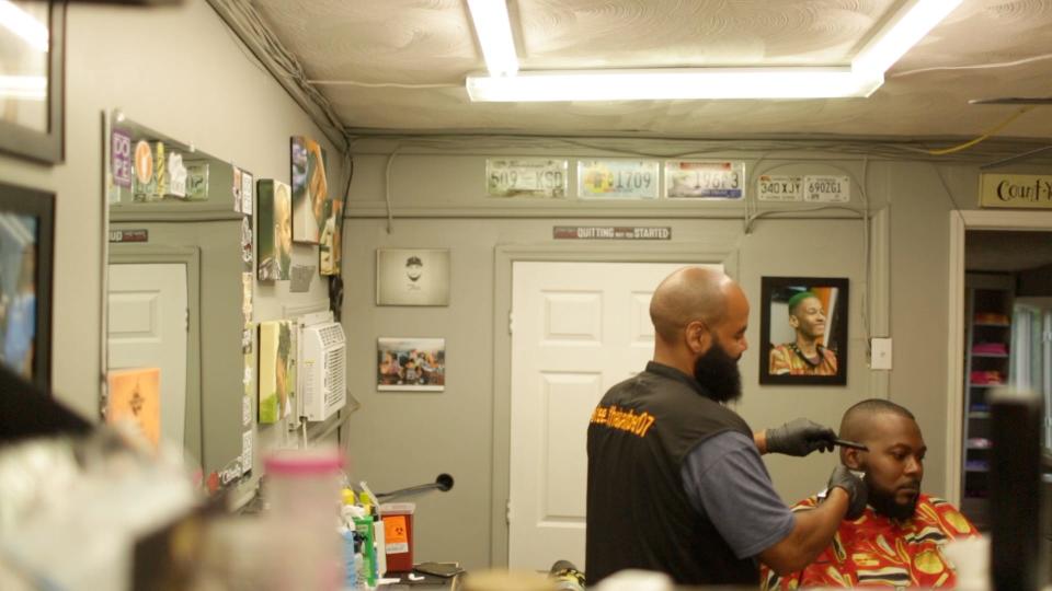 Finishing Touch Barbershop owner John T. Davis works inside the shop in along Woodland Street in near the intersection with East 8th Street in Columbia, Tenn, on Monday, June 7, 2021.