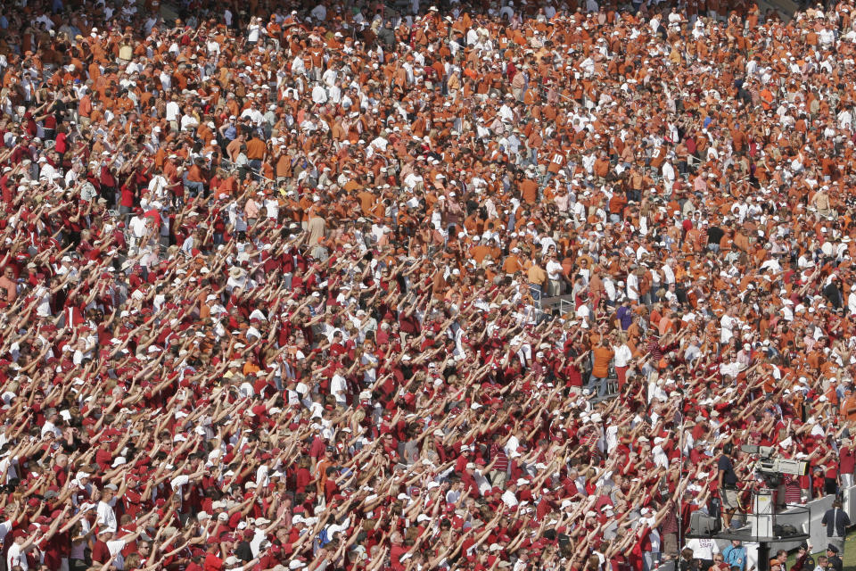 FILE - Oklahoma fans, at left in red, take up the south stands and Texas fans in burnt orange fill the north during an NCAA college football game at the Cotton Bowl in Dallas, Oct. 11, 2008. The Big 12 is losing its marquee matchup when the Red River Rivalry is played Saturday for the final time under the league’s umbrella. (AP Photo/Ron Heflin, File)