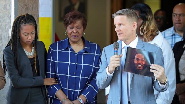 PHOTO: Attorney Bobby DiCello, right, holds up a photograph of Jayland Walker as Paige White, left, comforts Jayland's mother Pamela Walker during a press conference at St. Ashworth Temple on June 30, 2022, in Akron, Ohio. (Jeff Lange/USA Today Network)