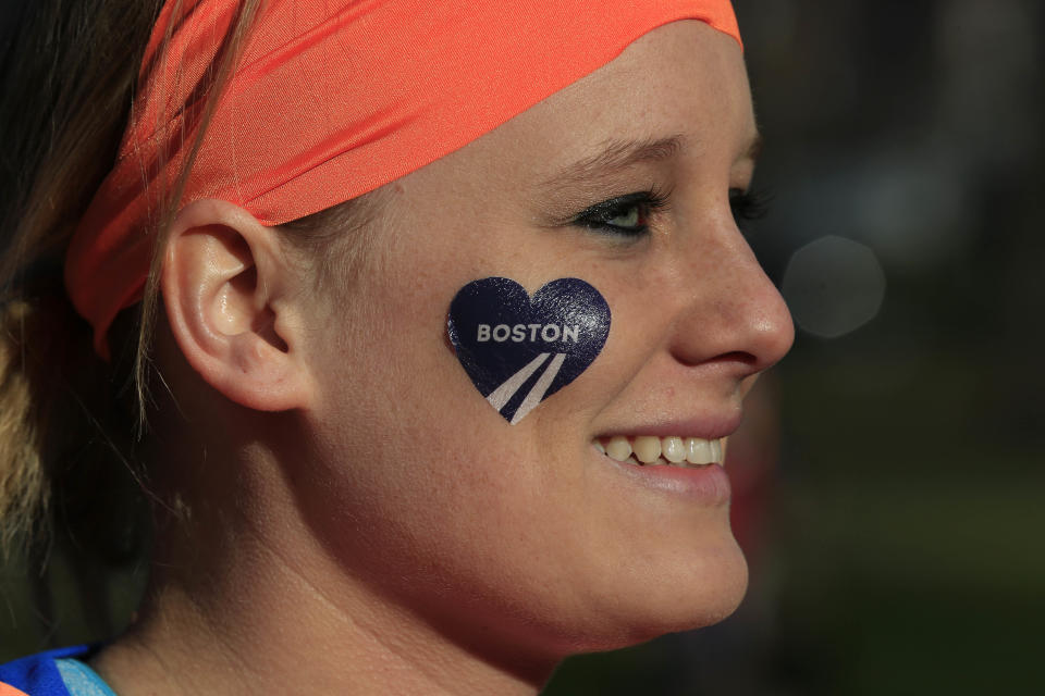Mackenzie Petermeier, of Baxter, Iowa, who will be a guide for a blind runner, waits to board a bus in Boston to the starting line in Hopkinton, Mass., for the 118th Boston Marathon Monday, April 21, 2014. (AP Photo/Matt Rourke)