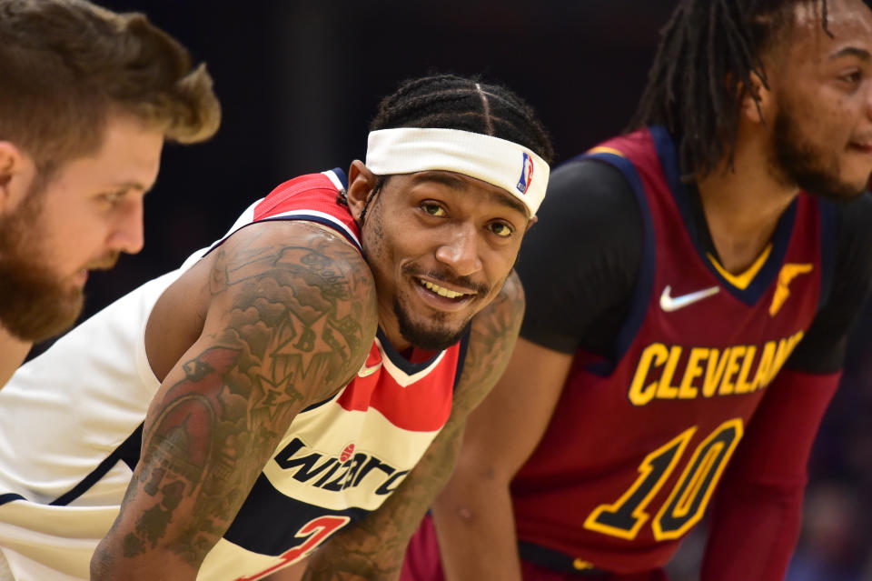 Bradley Beal jokes with Dean Wade and Darius Garland of the Cleveland Cavaliers during a free throw.