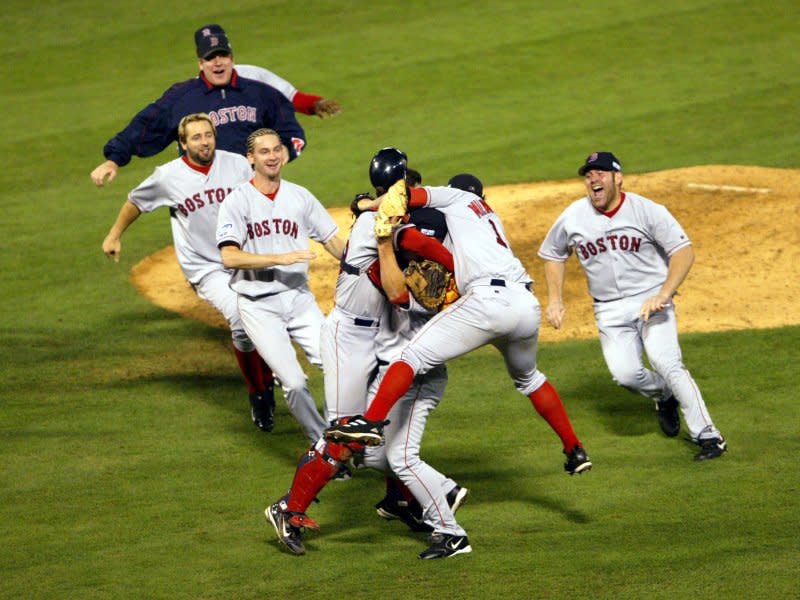 Members of the Boston Red Sox celebrate after the final out of Game 4 of the World Series beating the St. Louis Cardinals 3-0 at Busch Stadium in St. Louis on October 27, 2004. Boston took the World Championship for the first time since 1918. File Photo by Bill Greenblatt/UPI