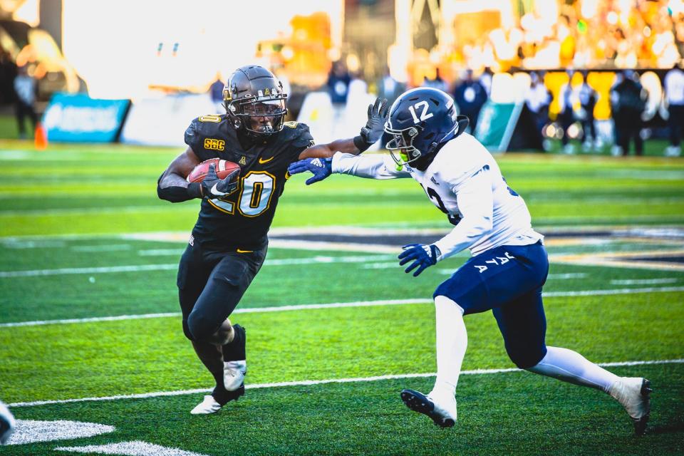 Appalachian State running back Nate Noel (20) tries to run past Georgia Southern safety Anthony Wilson on Saturday at Kidd Brewer Stadium in Boone, N.C.