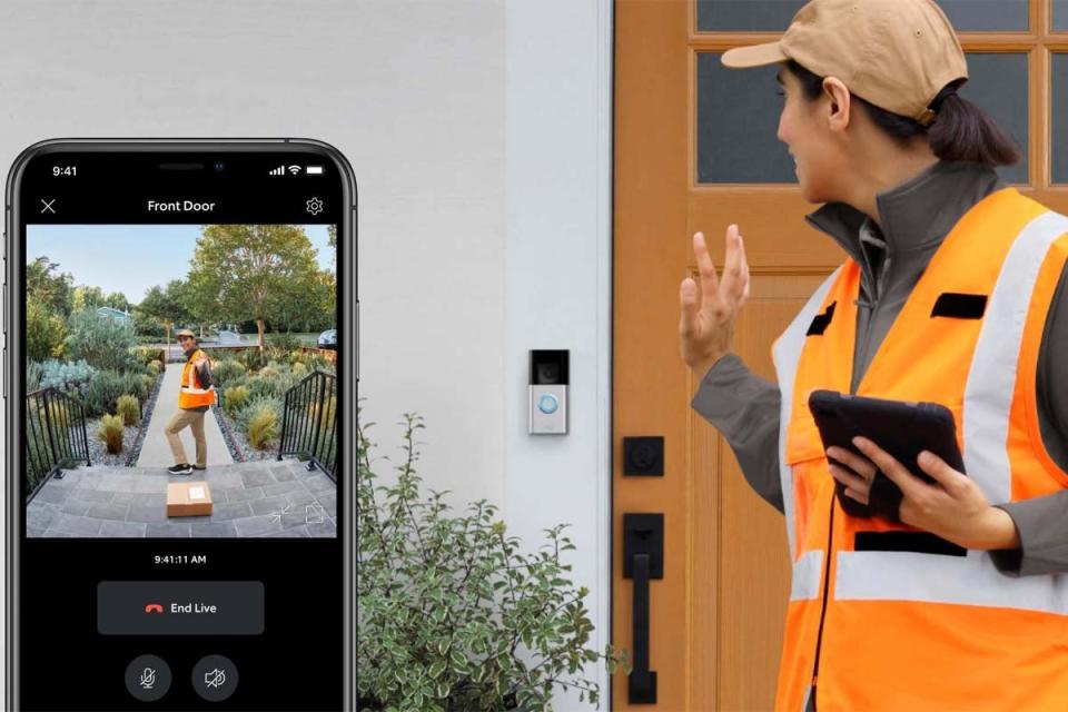 A worker in an orange vest waves at a Ring doorbell.