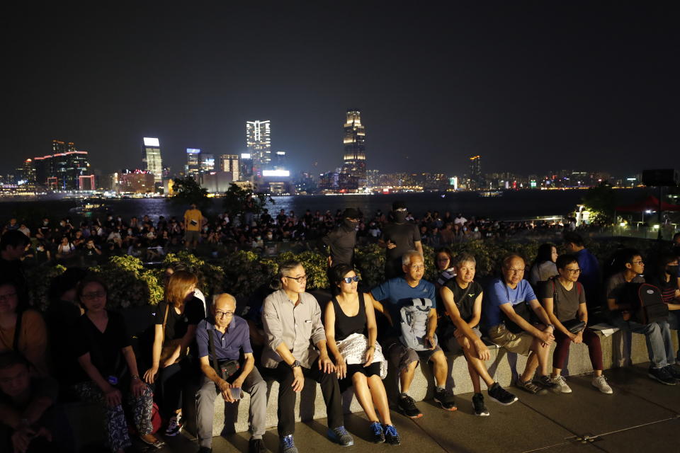 Protestors gather at Tamar Park in Hong Kong, Saturday, Sept. 28, 2019. Thousands of people have started to gather at a park in downtown Hong Kong, belting out songs and chanting slogans to mark the fifth anniversary of the Umbrella protests that called for democratic reforms in the semiautonomous Chinese territory. (AP Photo/Vincent Thian)