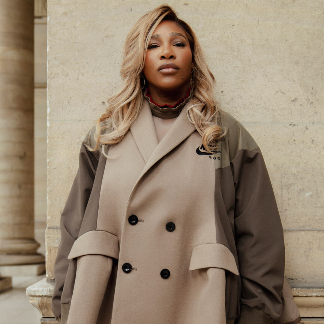  Serena Williams stands in front of a wall in Paris wearing a Nike camel trench coat. 