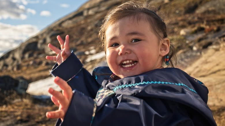 Inuit child doing jazz hands