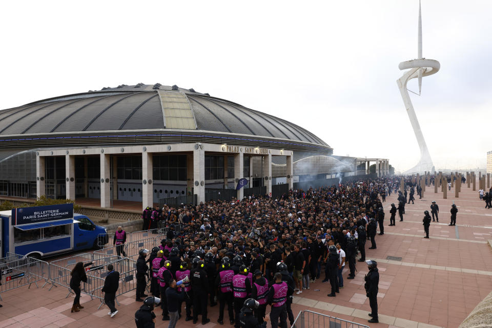 Paris Saint-Germain supporters arrive at the Olimpic Lluis Companys stadium for the Champions League quarterfinal second leg soccer match between Barcelona and Paris Saint-Germain in Barcelona, Spain, Tuesday, April 16, 2024. (AP Photo/Joan Monfort)