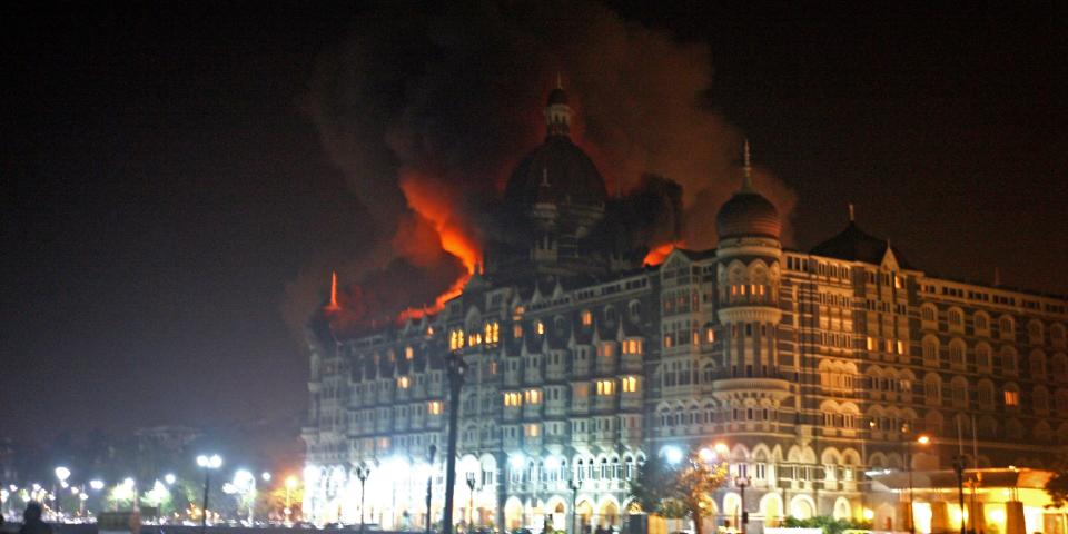 Fire breaks out at the Taj hotel in Mumbai on November 26, 2008. Nearly 80 people were killed in a series of shootings and blasts across Mumbai, when 10 Pakistani terrorists, armed men with automatic weapons and grenades, targeted two of Mumbai's top luxury hotels and the main Chhatrapati Shivaji railway station. Photo: PAL PILLAI/AFP via Getty Images