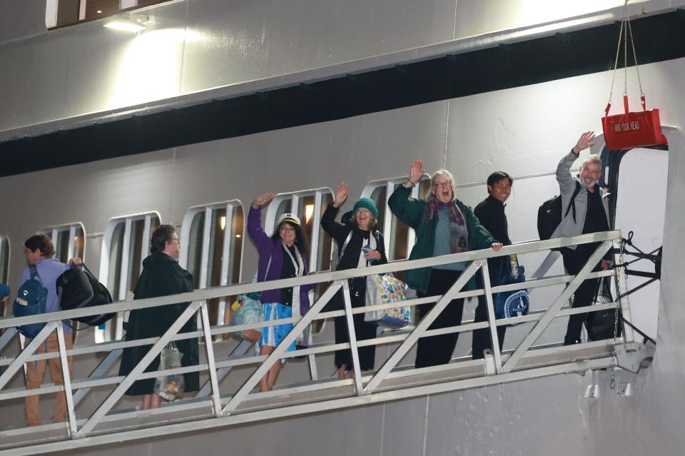 Passengers board the Villa Vie Odyssey cruise ship at Belfast Port's Cruise Ship Terminal earlier this week - but it's still yet to pull up anchor. (Getty)