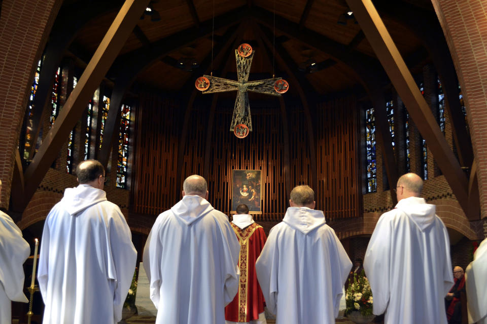 In this Dec. 26, 2019, photo, Benedictine monks of Saint Anselm Abbey celebrate mass in Manchester, New Hampshire. Monks at a Catholic college in New Hampshire have gone to court in a dispute with the school's board of trustees over an effort to limit their power. The two sides were in Hillsborough Superior Court on Monday, Jan. 6, 2020, over the lawsuit filed against the Saint Anselm College board last year. The unusual clash was set in motion when the board moved to take away the monks' ability to amend the school's bylaws. (AP Photo/Michael Casey)