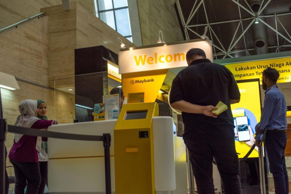 Customers inside a combined Malayan Banking Bhd. (Maybank) and Maybank Islamic Bhd. bank branch in Kuala Lumpur, Malaysia, on Tuesday, May 21, 2024. Maybank, Malaysia's largest lender, is scheduled to release earnings on May 24. Photographer: KG Krishnan/Bloomberg via Getty Images