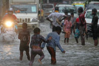 Children play on a flooded street during heavy rains in Mumbai, India on July 16, 2020. Monsoon in India officially lasts from June to September. (Photo by Himanshu Bhatt/NurPhoto via Getty Images)