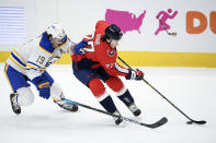 Washington Capitals right wing T.J. Oshie (77) skates with the puck next to Buffalo Sabres defenseman Jake McCabe (19) during the first period of an NHL hockey game, Sunday, Jan. 24, 2021, in Washington. (AP Photo/Nick Wass)