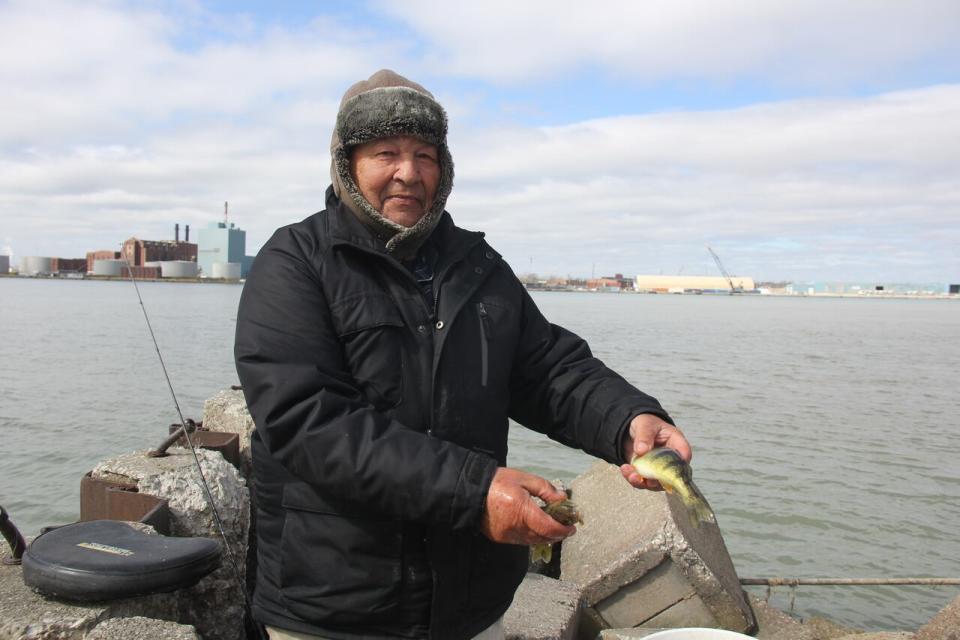 Amateur angler Joseph  Joseph Rostkowicz shows off the yellow perch he caught out of the Detroit River in Windsor's west end on March 8, 2024.