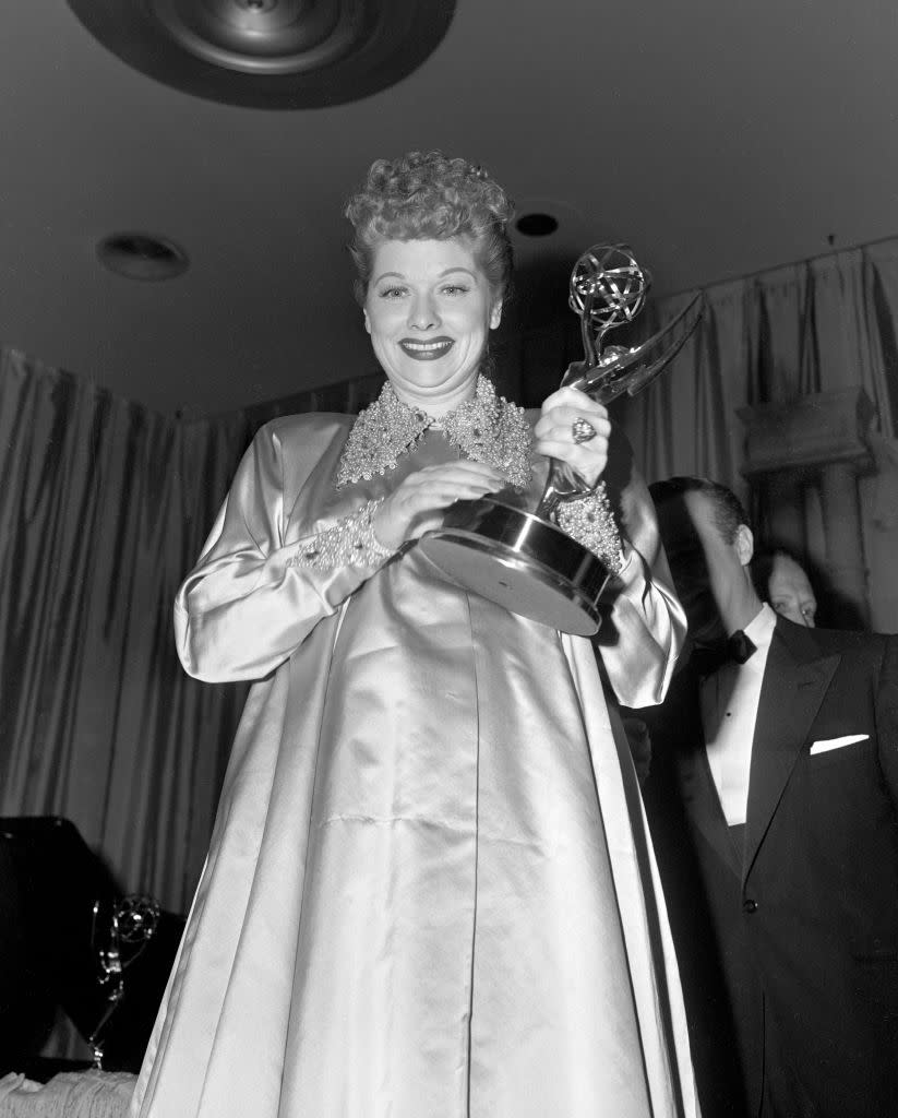 <p>Lucille Ball won several Primetime Emmy Awards for her groundbreaking sitcom <em>I Love Lucy</em>, and she's photographed here taking home an award at the 5th annual Emmy Awards in 1953.</p>