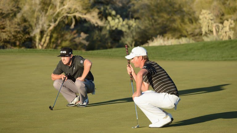 Hunter Mahan (L) and Webb Simpson line up their putts on the 18 hole during the quarter-final of the WGC Match Play Championship on February 23, 2013. Mahan, trying to join Tiger Woods as the only players to win back-to-back titles in this event, defeated US Open champion Simpson 1-up