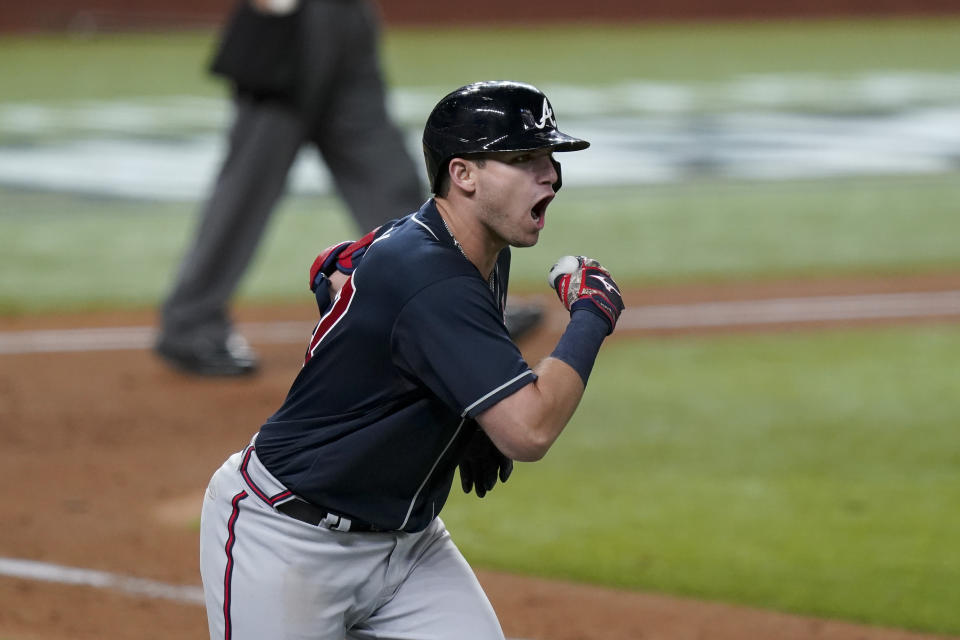 Atlanta Braves' Austin Riley celebrates a run home against the Los Angeles Dodgers during the ninth inning in Game 1 of a baseball National League Championship Series Monday, Oct. 12, 2020, in Arlington, Texas. (AP Photo/Eric Gay)
