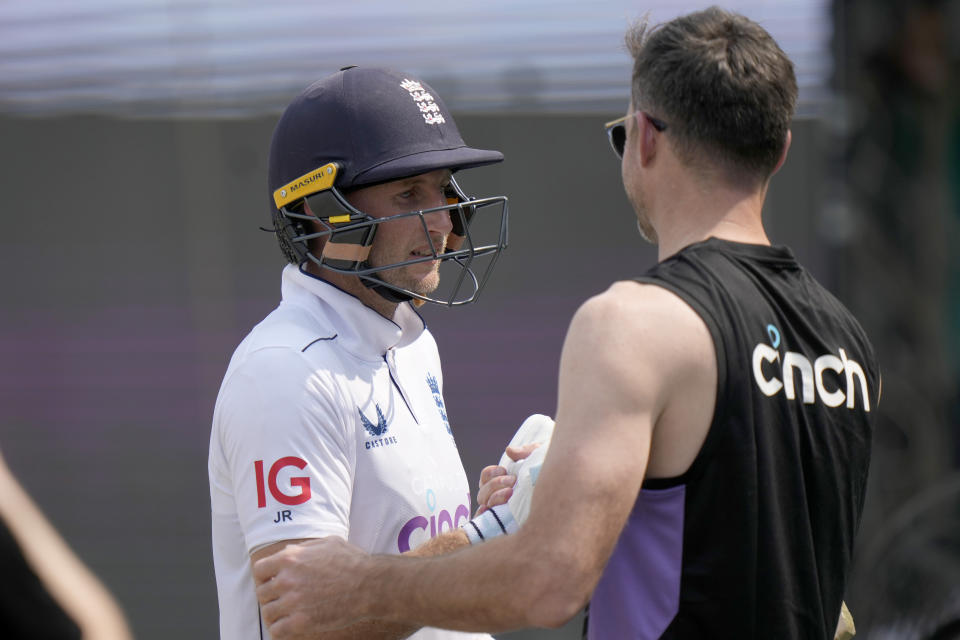 England's Joe Root, left, who is now England's leading test run-scorer. is congratulated by James Anderson as he walks off the field on the lunch break during the third day of the first test cricket match between Pakistan and England, in Multan, Pakistan, Wednesday, Oct. 9, 2024. (AP Photo/Anjum Naveed)