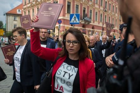 Leaders of opposition party Nowoczesna Kamila Gasiuk-Pihowicz and Katarzyna Lubnauer carry the copies of Polish Constitution as they leave after boycotting the special joint session of Polish parliament, held to mark the centennial of Polish independence and 550 years of parliamentary traditions, in Warsaw, Poland, July 13, 2018. Agencja Gazeta/Slawomir Kaminski via REUTERS ATTENTION EDITORS - THIS IMAGE WAS PROVIDED BY A THIRD PARTY. POLAND OUT. NO COMMERCIAL OR EDITORIAL SALES IN POLAND.