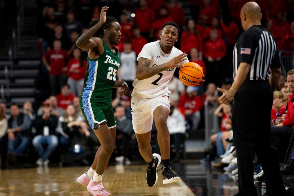 Cincinnati Bearcats guard Landers Nolley II (2) makes his way toward the basket during UC's opening AAC game against Tulane back in December. He is being guarded by Tulane's Jaylen Forbes (25).