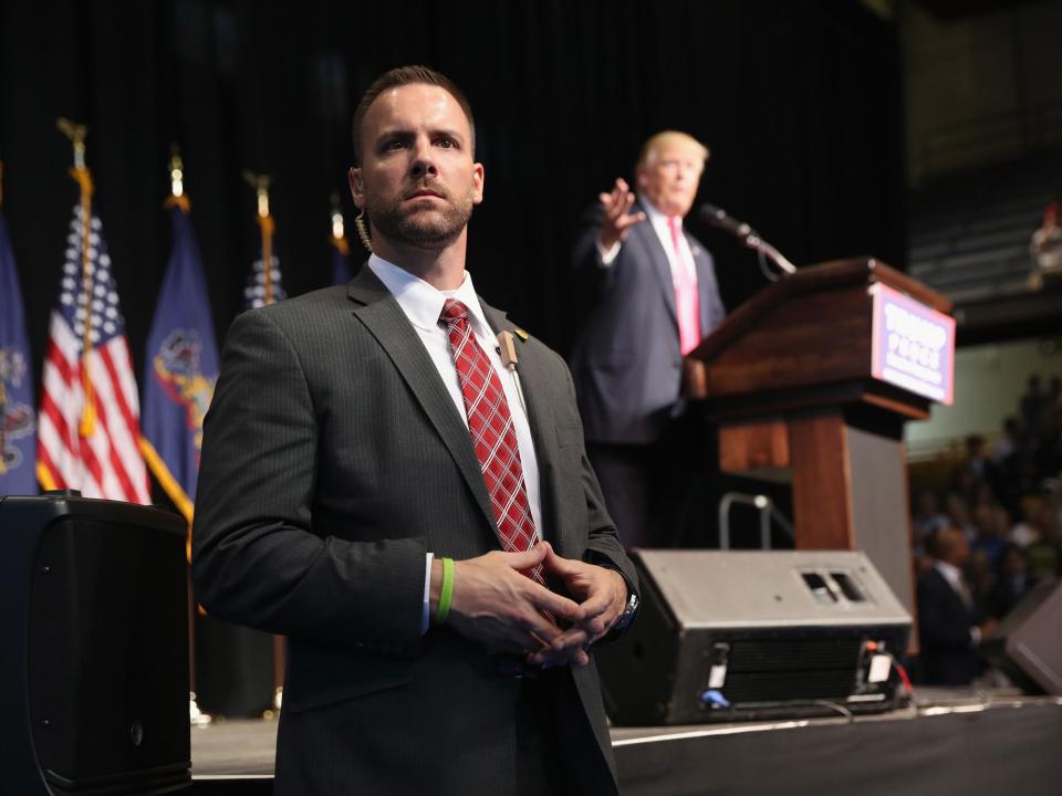 A Secret Service agent stands guard as Mr Trump makes a speech on the campaign trail in 2016: John Moore/Getty Images