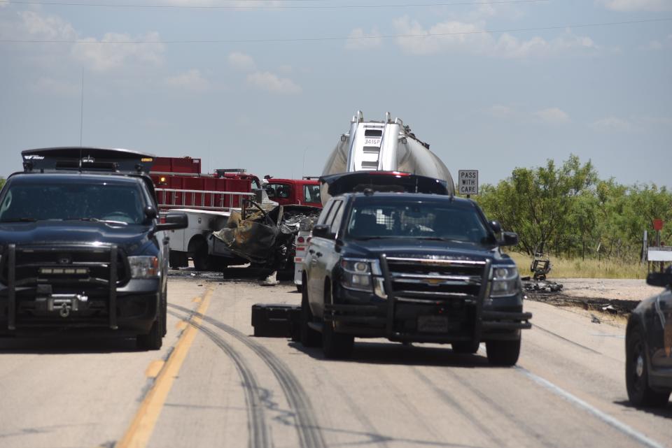 New Mexico State Police respond to a fatal crash involving a pickup truck and a semi truck along State Route 128 near Jal, New Mexico, on Thursday, July 11, 2019. Authorities say four oilfield workers traveling in the truck and the driver of the rig were pronounced dead at the scene.(Jason Farmer/The Hobbs Daily News-Sun via AP)
