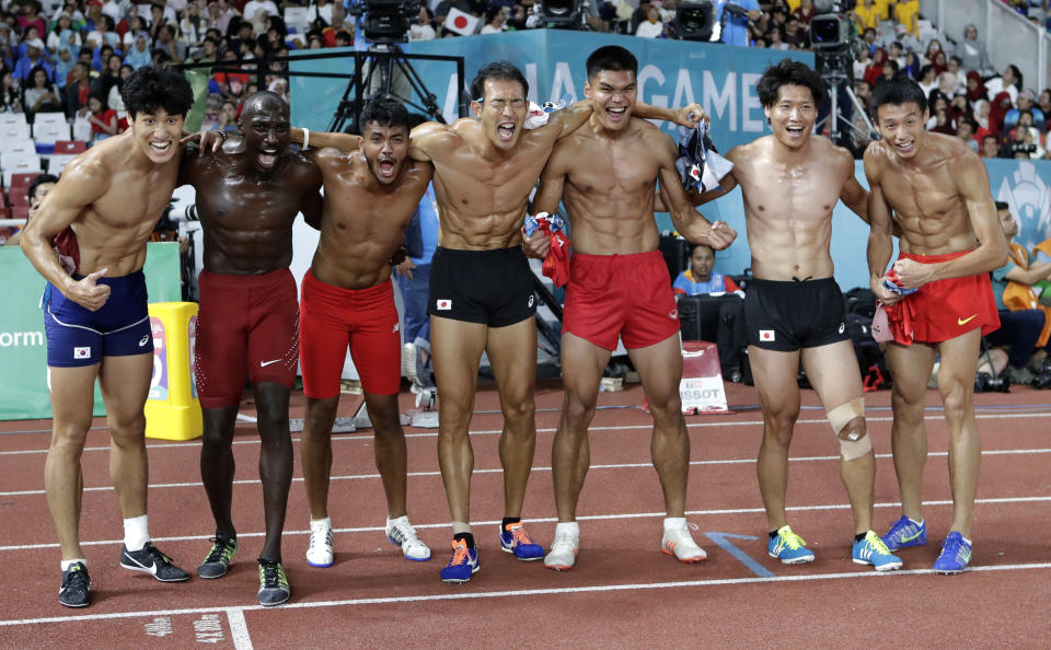 Decathlete's celebrate after completing their last event during the athletics competition at the 18th Asian Games in Jakarta, Indonesia, Sunday, Aug. 26, 2018. (AP Photo/Lee Jin-man)