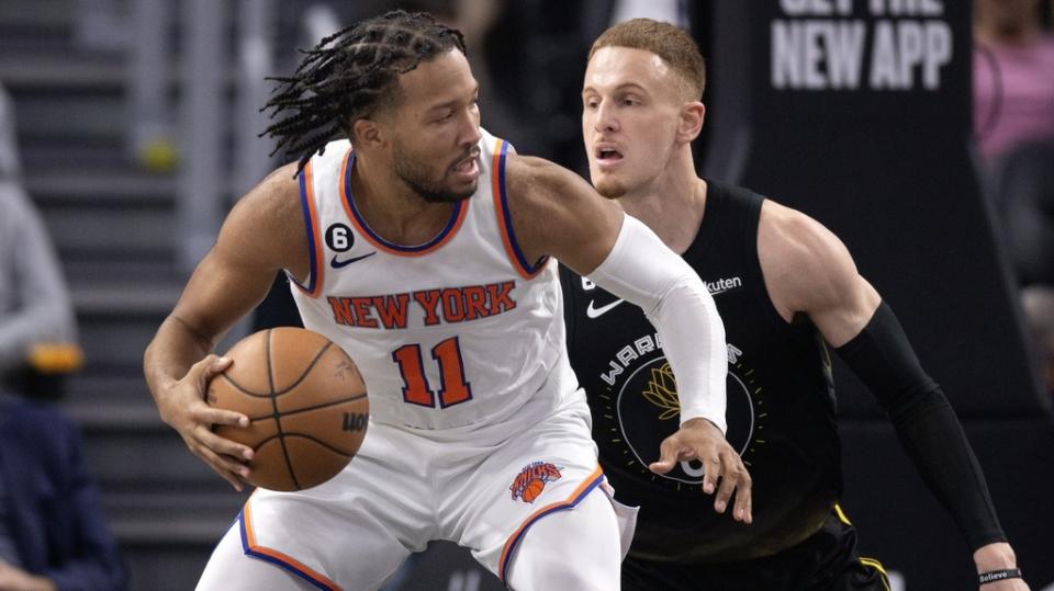 Nov 18, 2022; San Francisco, California, USA; New York Knicks guard Jalen Brunson (11) tries to drive on Golden State Warriors guard Donte DiVincenzo (0) during the fourth quarter at Chase Center.