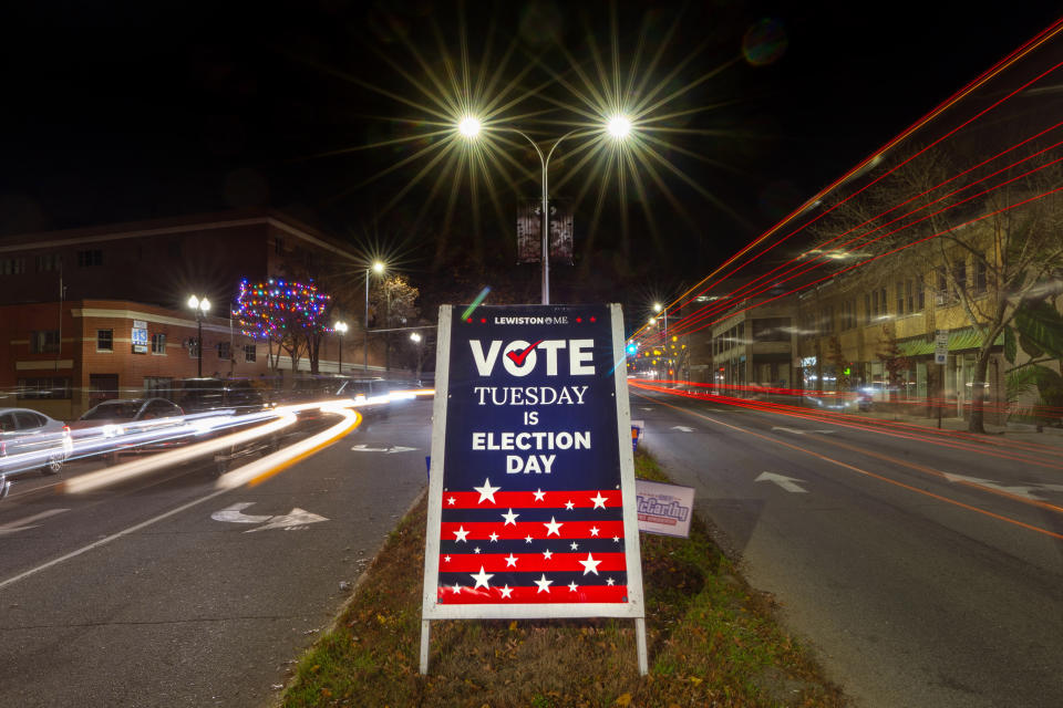 FILE - A sign reminds residents to do their civic duty on Election Day, Nov. 8, 2022, in Lewiston, Maine. Maine's vaunted independent voters are becoming scarcer as Super Tuesday approaches. (AP Photo/Robert F. Bukaty, File)