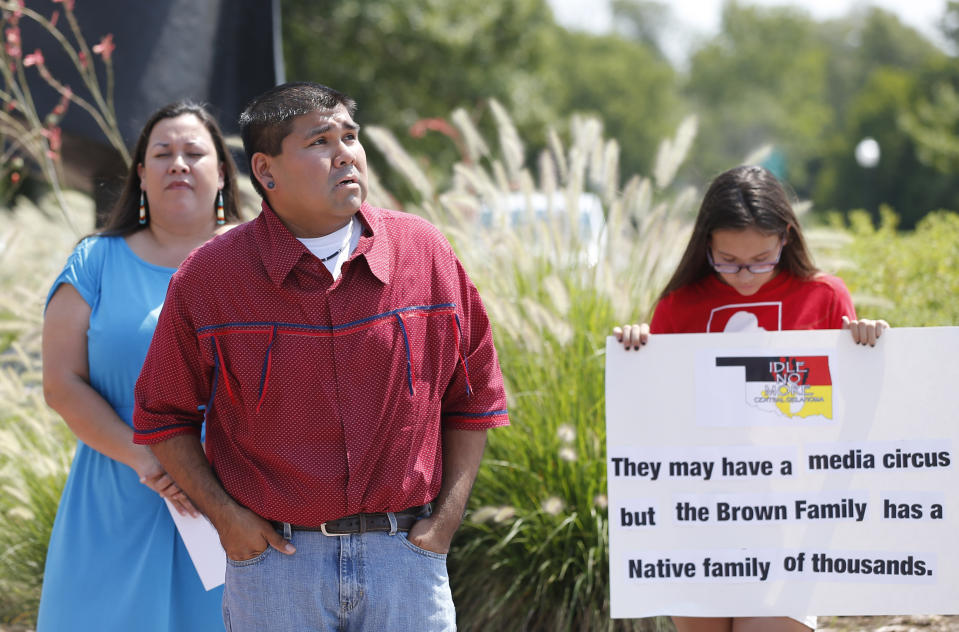 FILE - Chebon Kernell, center, an elder in the United Methodist Church and a member of the Seminole Nation, prays at the start of a rally in support of three-year-old baby Veronica, Veronica's biological father, Dusten Brown, and the Indian Child Welfare Act, in Oklahoma City, Monday, Aug. 19, 2013. Brown is trying to maintain custody of the girl who was given up for adoption by her birth mother to a couple in South Carolina. The U.S. Supreme Court says Brown cannot use the Indian Child Welfare Act to press his claims. The U.S. Supreme Court will hear arguments, Wednesday, Nov. 9, 2022 on the most significant challenge to the Indian Child Welfare Act that gives preference to Native American families in foster care and adoption proceedings of Native American children since it passed in 1978. (AP Photo/Sue Ogrocki, File)